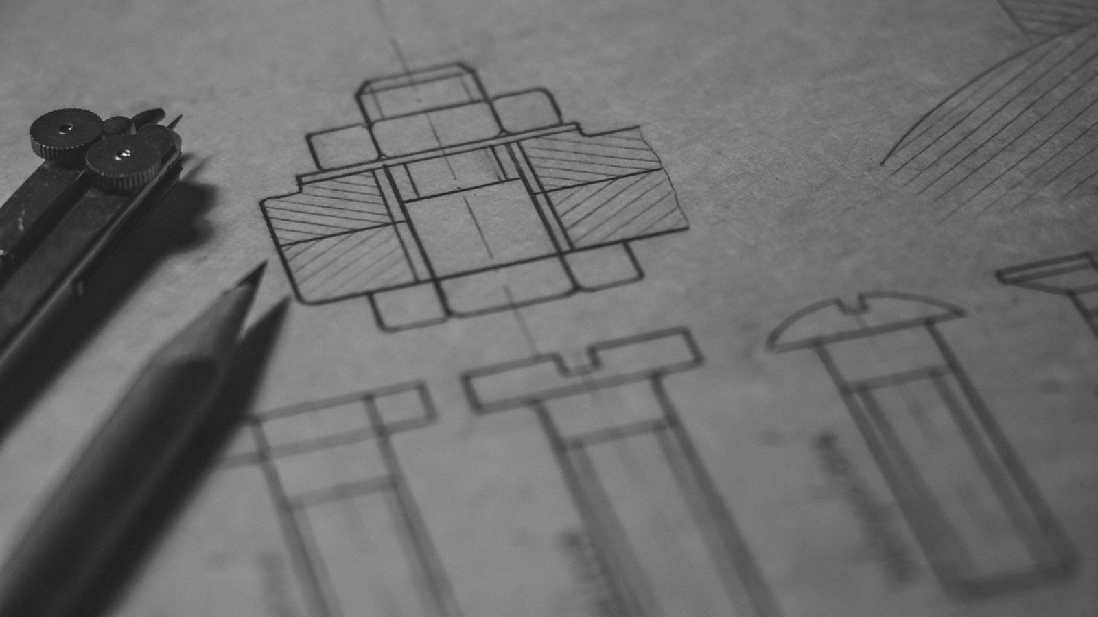 A hand-drafted black-and-white technical drawing on paper with a brass drafting compass