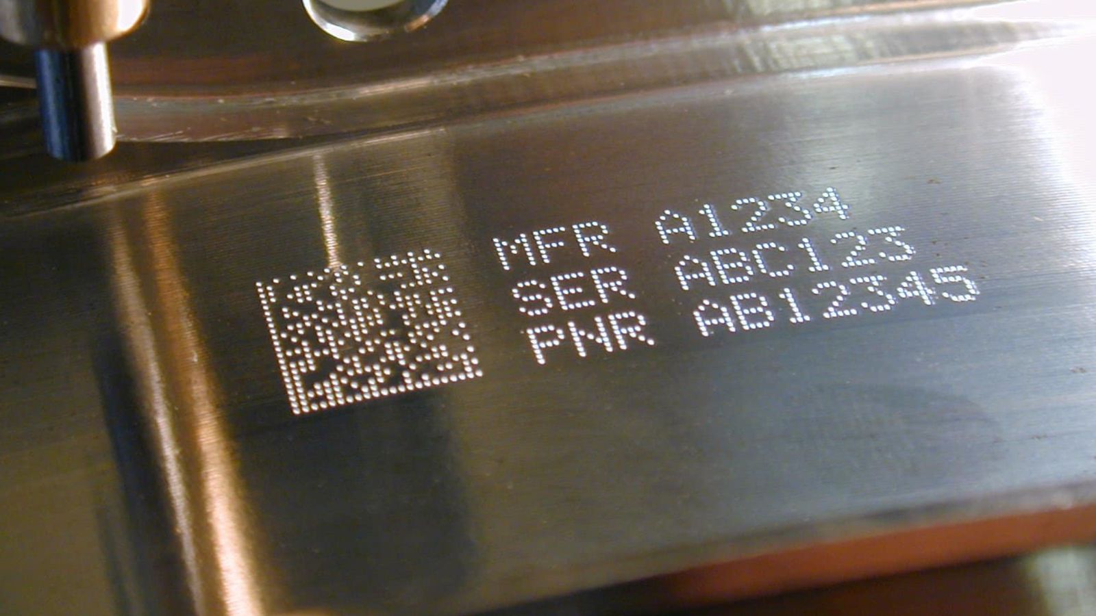 Laser-marked DataMatrix code and manufacturer, serial and part numbers on a machined metal surface